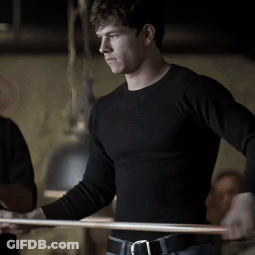 Man In Black Shirt Standing In Dark Room GIF