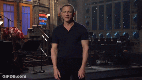 Man In Black Shirt Standing In Front Of Ladies Sign GIF
