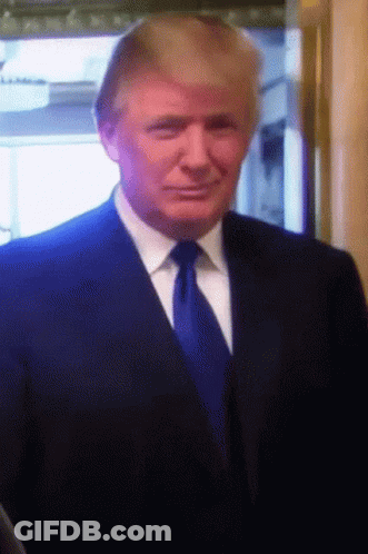 Man In Black Shirt Standing In Front Of Sign Saying Yes Is The Answer GIF