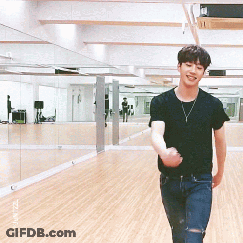 Man In Black Shirt Standing In Mirrored Room GIF