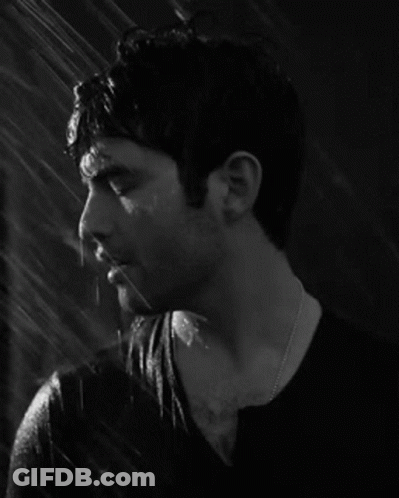 Man In Black Shirt Standing In Rain GIF