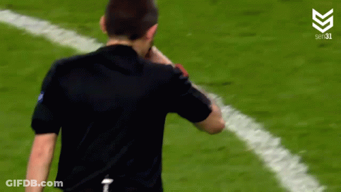Man In Black Shirt Standing On Soccer Field Hands On Hips GIF