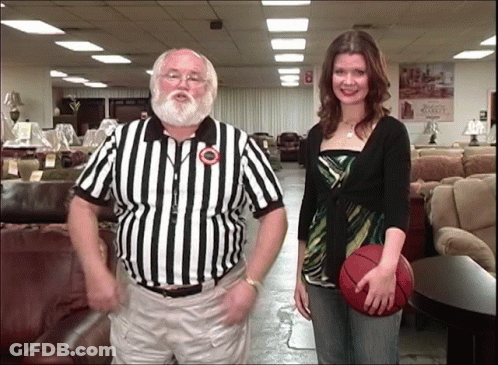 Man In Black Shirt Standing On Soccer Field Hands On Hips GIF