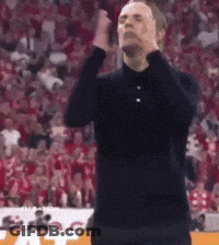 Man In Black Shirt Standing With Hands On Head GIF