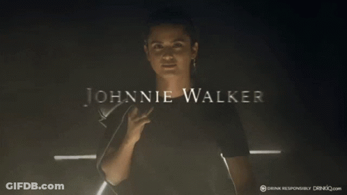 Man In Black Shirt Surrounded By Johnnie Walker Logo GIF
