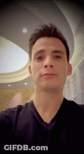 Man In Black Shirt Taking Selfie Under Ceiling GIF
