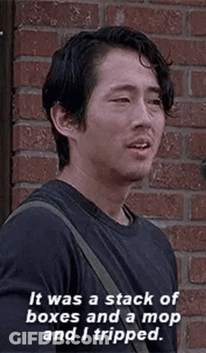 Man In Black Shirt Talking In Front Of Brick Wall GIF