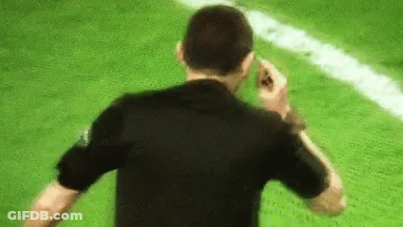 Man In Black Shirt Talking On Cell Phone Soccer Field GIF