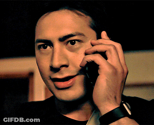 Man In Black Shirt Talking On Cellphone GIF