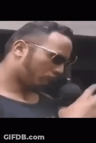 Man In Black Shirt Talking On Phone GIF