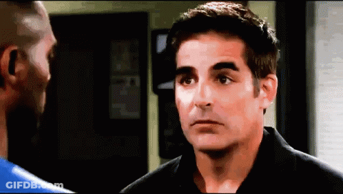 Man In Black Shirt Talking To Man In Blue Shirt GIF