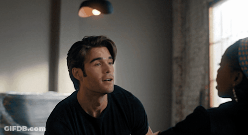 Man In Black Shirt Talking To Woman In Head Scarf GIF