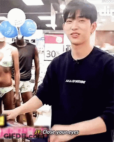 Man In Black Shirt Tells Woman In Bikini Close Your Eyes GIF