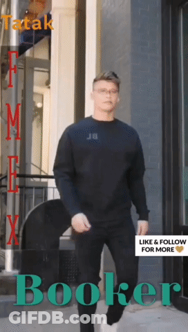 Man In Black Shirt Walking Down Street Booker GIF