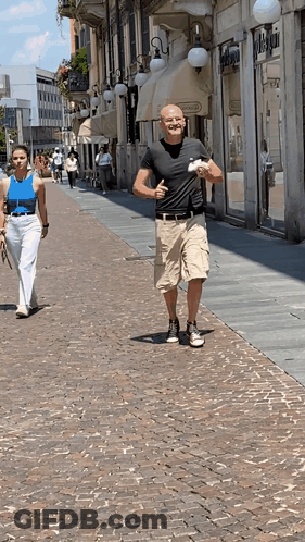 Man In Black Shirt Walking With Woman In Blue Tank Top GIF