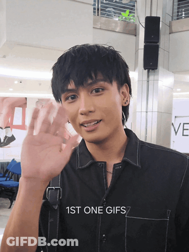 Man In Black Shirt Waving Hand GIF