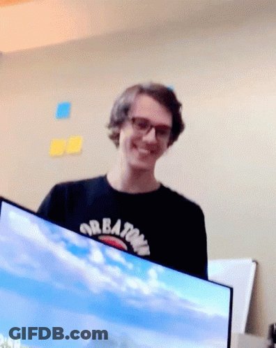 Man In Black Shirt With Creations Smiles GIF