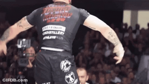 Man In Black Shirt With Distillery On Back GIF