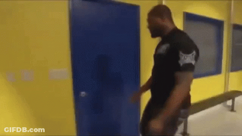 Man In Black Shirt With Everlast Walking Through Blue Door GIF