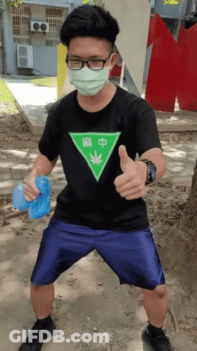 Man In Black Shirt With Green Triangle And Marijuana Leaf GIF