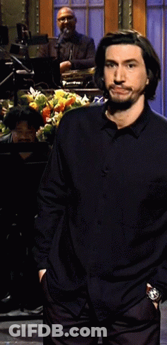 Man In Black Shirt With Hands In Pockets On Stage GIF