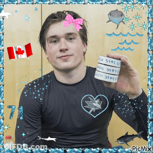 Man In Black Shirt With Hearts And Sharks Holding Paper GIF