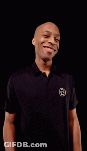 Man In Black Shirt With Letter B Smiles GIF
