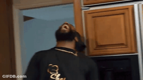 Man In Black Shirt With Letter C In Kitchen GIF