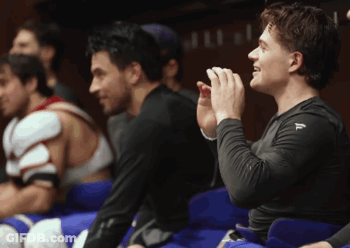Man In Black Shirt With Letter F In Locker Room GIF