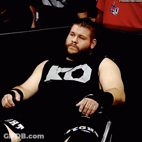 Man In Black Shirt With Letter K In Wheelchair GIF