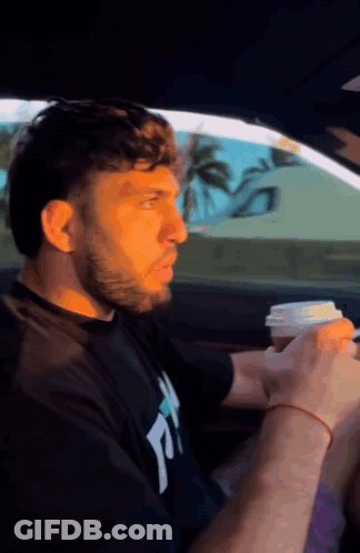 Man In Black Shirt With Letter T Drinking Coffee GIF