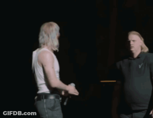 Man In Black Shirt With Letter V Next To Another Man GIF