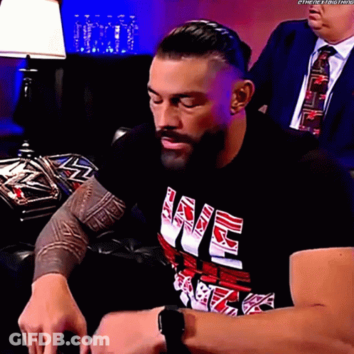 Man In Black Shirt With Love Sitting On Couch GIF