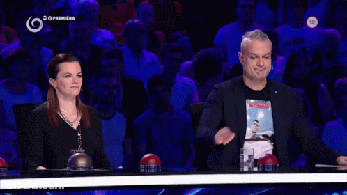 Man In Black Shirt With Picture Stands Next To Woman GIF