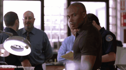 Man In Black Shirt With Police Patch GIF