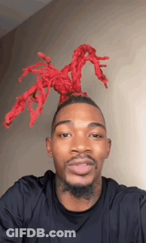 Man In Black Shirt With Red Spider In Hair GIF