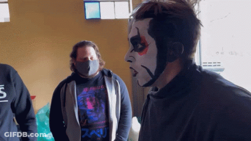Man In Black Shirt With S Next To Face Painted Man GIF