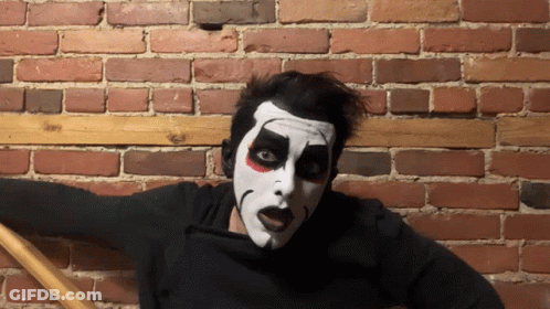 Man In Black Shirt With S Next To Face Painted Man GIF