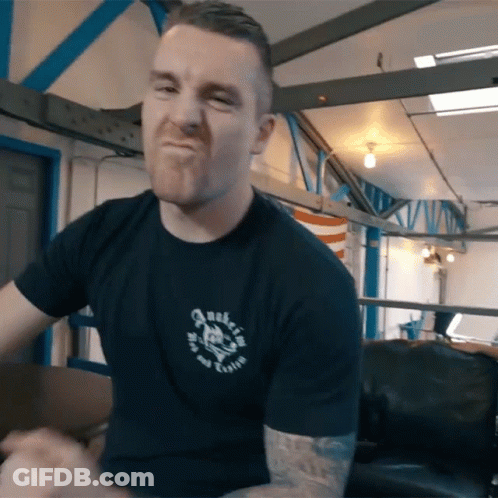 Man In Black Shirt With Skull Making A Face GIF