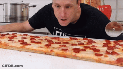 Man In Black Shirt With T Looking At Long Pepperoni Pizza GIF