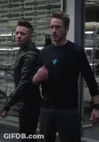 Man In Black Shirt With Triangle Next To Man In Black Jacket GIF