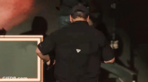 Man In Black Shirt With White Triangle GIF
