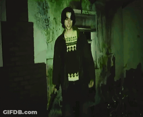Man In Black Skull Shirt Pointing At Camera GIF