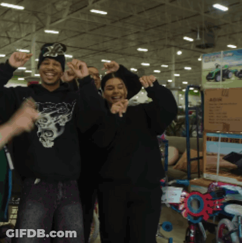 Man In Black Skull Sweatshirt Next To Woman GIF