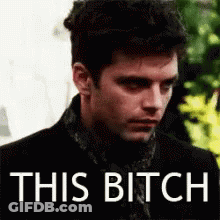 Man In Black Suit And Scarf Saying This Bitch GIF