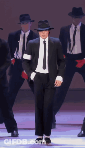 Man In Black Suit And Tie Dancing GIF