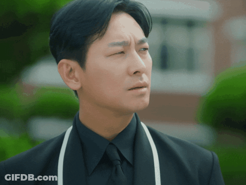 Man In Black Suit And White Apron GIF