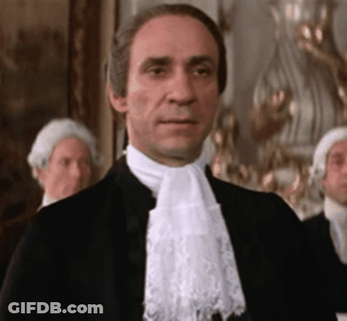 Man In Black Suit And White Lace Scarf GIF