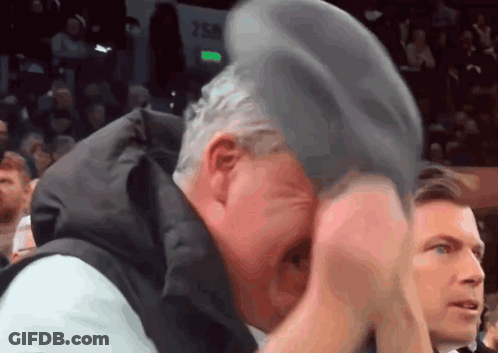 Man In Black Suit Bending Over On Knees GIF