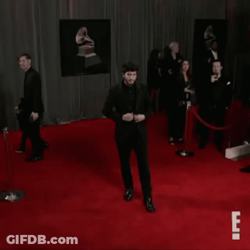 Man In Black Suit Dancing On Red Carpet GIF